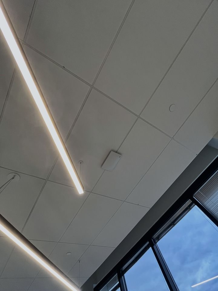 Wireless access point installed on a drop ceiling in an open office